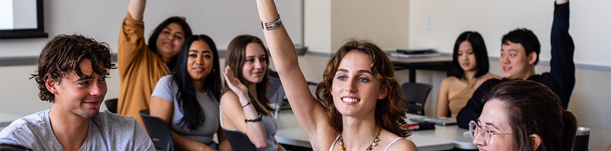 SBCC classroom with students raising their hands